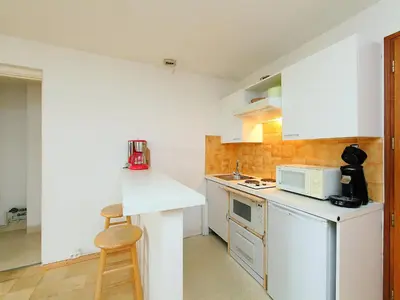 a small kitchen with a counter and a microwave at Apartment L'Univers by Interhome in Chamonix-Mont-Blanc