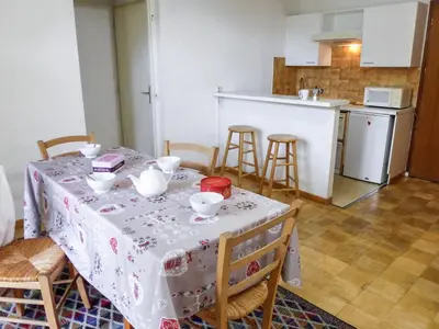 a kitchen with a table with a white table cloth at Apartment L'Univers by Interhome in Chamonix-Mont-Blanc