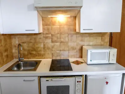 a kitchen with a sink and a microwave at Apartment L'Univers by Interhome in Chamonix-Mont-Blanc