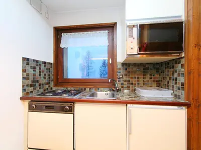 a kitchen with a sink and a window at Holiday Home Les Pelarnys by Interhome in Chamonix-Mont-Blanc