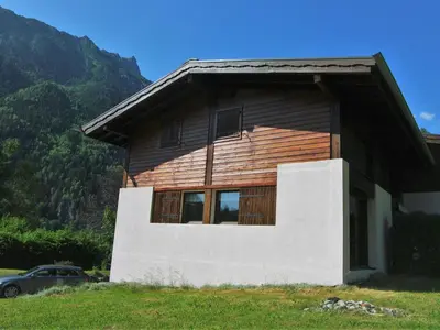 a wooden house with a car parked in front of it at Holiday Home Les Pelarnys by Interhome in Chamonix-Mont-Blanc