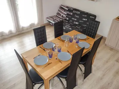 a dining room table with chairs and a wooden table at Apartment La Borgia A- B- C-10 by Interhome in Les Contamines-Montjoie