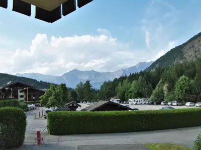 a view of a parking lot with mountains in the background at Apartment L'Hermine by Interhome in Les Houches