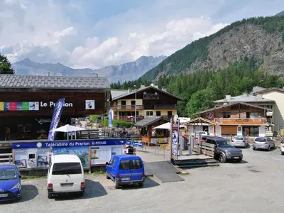 a group of cars parked in a parking lot in front of buildings at Apartment L'Hermine by Interhome in Les Houches