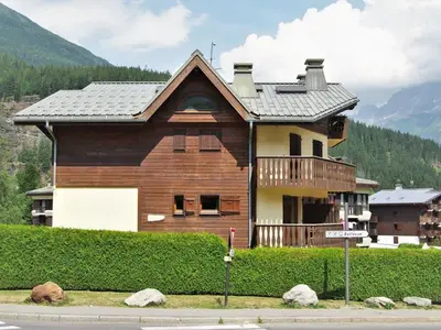 a large wooden house on the side of a street at Apartment L'Hermine by Interhome in Les Houches