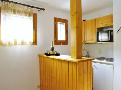 a kitchen with a counter with a bottle of wine on it at Apartment L'Hermine by Interhome in Les Houches