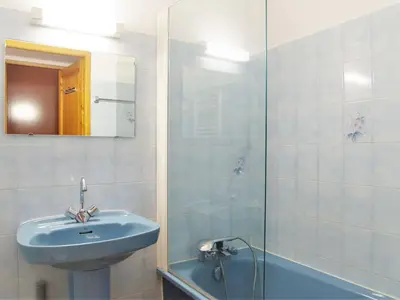 a bathroom with a sink and a glass shower at Apartment L'Hermine by Interhome in Les Houches