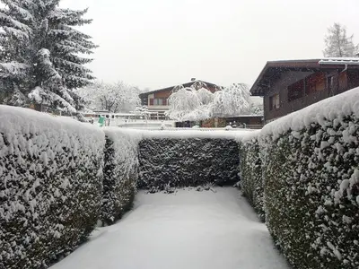 a fence covered in snow next to a house at Studio Les Chamois by Interhome in Les Houches