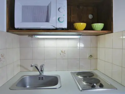 a kitchen counter with a sink and a microwave at Studio Les Chamois by Interhome in Les Houches