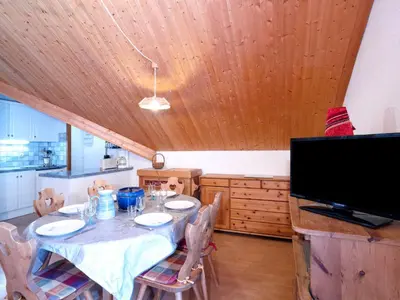 a dining room with a table and a tv at Apartment Les Combettes D et E by Interhome in Les Contamines-Montjoie