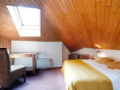 a bed in a room with a wooden ceiling at Apartment Les Combettes D et E by Interhome in Les Contamines-Montjoie