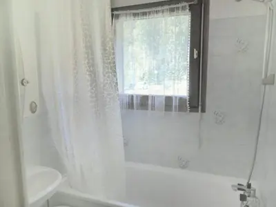 a bathroom with a white shower curtain and a window at Apartment La Borgia A- B- C-1 by Interhome in Les Contamines-Montjoie