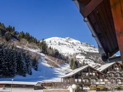 a ski lodge with a snow covered mountain in the background at Apartment La Borgia A- B- C-1 by Interhome in Les Contamines-Montjoie