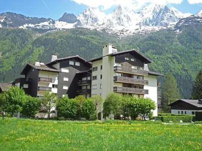 a kitchen with a white refrigerator and a table at Studio Clos du Savoy-22 by Interhome in Chamonix-Mont-Blanc