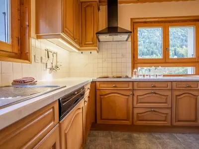 a kitchen counter with a blue tea pot on a cutting board at Chalet Chalet Mendiaux by Interhome in Saint-Gervais-les-Bains
