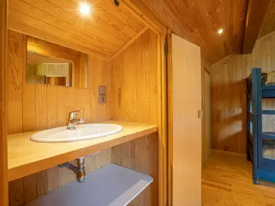 a bedroom with two bunk beds and a wooden wall at Chalet Chalet Mendiaux by Interhome in Saint-Gervais-les-Bains
