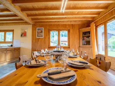 a dining room with a large wooden table and chairs at Chalet Chalet Mendiaux by Interhome in Saint-Gervais-les-Bains