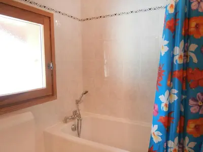 a bathroom with a tub and a shower curtain at Apartment Le Tagre by Interhome in Mémontel