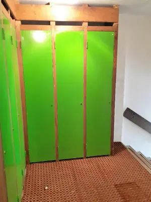 a green door in a room with a wall at Saint Gervais - Le Bettex T3 Duplex (1400m d'altitude)/ 55m2 / Vue Mont Blanc - Aux Pieds des Pistes! in Saint-Gervais-les-Bains