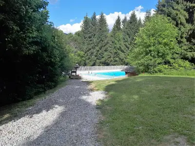 a large yard with a swimming pool and trees at Saint Gervais - Le Bettex T3 Duplex (1400m d'altitude)/ 55m2 / Vue Mont Blanc - Aux Pieds des Pistes! in Saint-Gervais-les-Bains