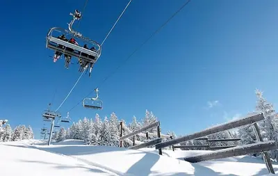 a group of people riding a ski lift in the snow at Saint Gervais - Le Bettex T3 Duplex (1400m d'altitude)/ 55m2 / Vue Mont Blanc - Aux Pieds des Pistes! in Saint-Gervais-les-Bains