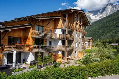 a large wooden house with balconies on a mountain at La Cordee 504 Apartment - Chamonix All Year in Chamonix-Mont-Blanc
