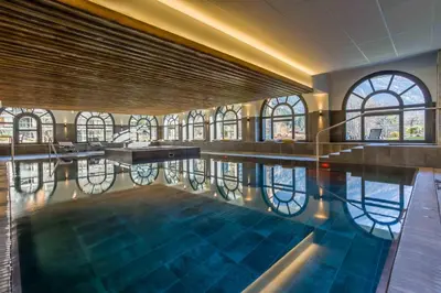 a swimming pool in a building with windows at La Cordee 504 Apartment - Chamonix All Year in Chamonix-Mont-Blanc