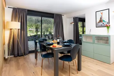 a kitchen and dining room with a table and chairs at La Cordee 504 Apartment - Chamonix All Year in Chamonix-Mont-Blanc