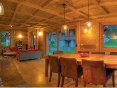 a living room with a wooden table and chairs at CHALET CHAM'ROCK in Les Houches