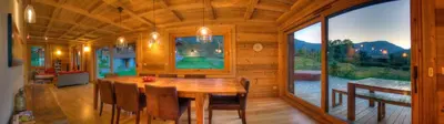 a wooden dining room with a wooden table and chairs at CHALET CHAM'ROCK in Les Houches