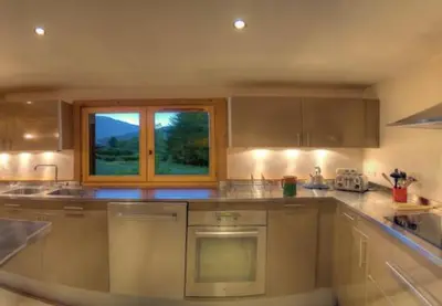 a kitchen with a sink and a window at CHALET CHAM'ROCK in Les Houches