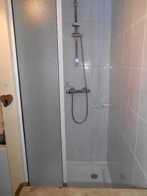 a shower in a bathroom with a glass door at LES CARROZ LE LAYS cosy apartment 40M2 vue montagne plein sud in Les Carroz d'Araches