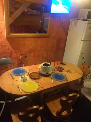 a wooden table with a pot on top of it at LES CARROZ LE LAYS cosy apartment 40M2 vue montagne plein sud in Les Carroz d'Araches