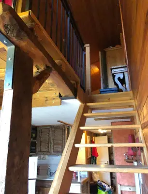 a wooden stairway in a house with a room at LES CARROZ LE LAYS cosy apartment 40M2 vue montagne plein sud in Les Carroz d'Araches