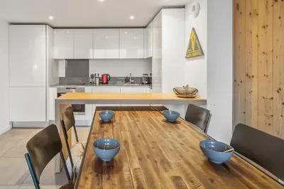 a kitchen with a wooden table with blue bowls on it at Résidence Luxe 5*,Spa & Fitness, La Cordée Appartement 214 in Chamonix-Mont-Blanc