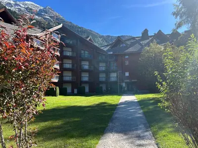 a large building with a pathway in front of it at L'Enclave in Les Contamines-Montjoie