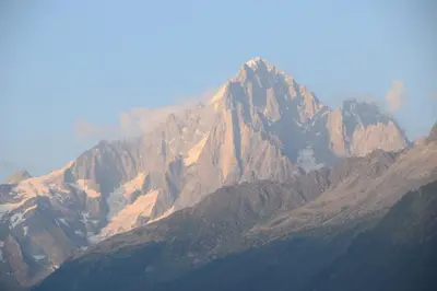 a view of a mountain with smoke coming out of it at Spacious Apartment 2 Minutes from Ski Lift, Equipped for Babies in Les Houches