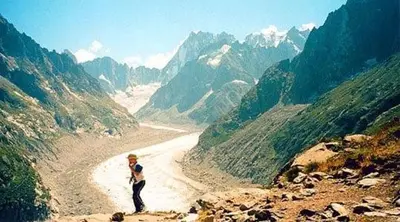 a man standing on a mountain looking at a valley at Spacious Apartment 2 Minutes from Ski Lift, Equipped for Babies in Les Houches