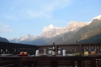 a table with a view of the mountains at Spacious Apartment 2 Minutes from Ski Lift, Equipped for Babies in Les Houches