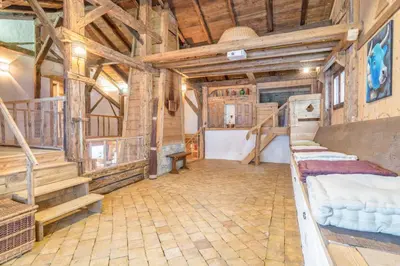 a bedroom in a log cabin with two beds at Le Charmélie 1600 in Flaine