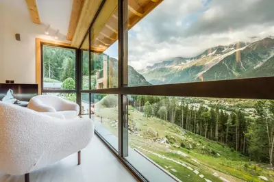 a room with a large window with a mountain view at Le Chalet Mont Blanc in Les Houches