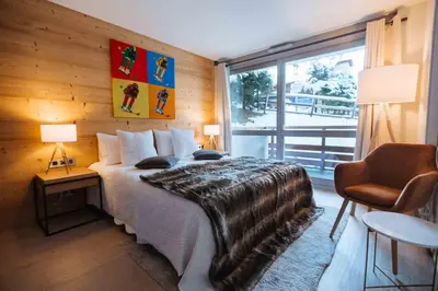 a bedroom with a bed and a large window at Wonderful 2 bedroms – Vacances Megeve – AW101 in Megève