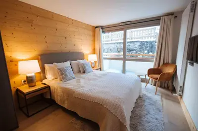 a bedroom with a bed and a large window at Wonderful 2 bedroms – Vacances Megeve – AW101 in Megève