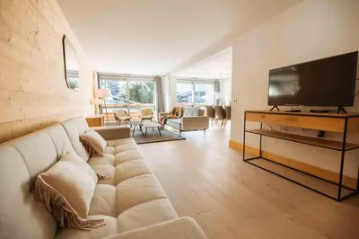 a living room with a couch and a flat screen tv at Wonderful 2 bedroms – Vacances Megeve – AW101 in Megève