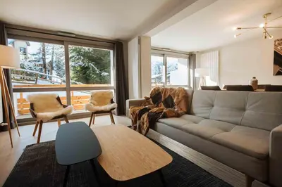 a living room with a couch and a table at Wonderful 2 bedroms – Vacances Megeve – AW101 in Megève