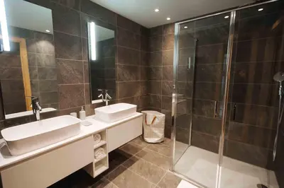 a bathroom with two sinks and a shower at Fabulous Residence Lesporting Ski - AE203 in Megève