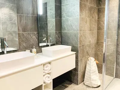 a bathroom with two sinks and a shower at Residence Lesporting Ski – Megeve – АW201 in Megève
