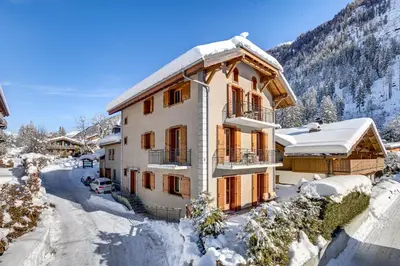 a house in the snow with a mountain at Villa Mont Blanc in Chamonix-Mont-Blanc