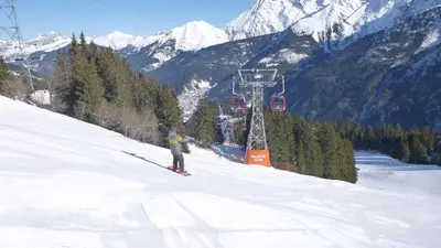 a person is skiing down a snow covered mountain at Le Lièvre Blanc, appartement N°2 in Les Contamines-Montjoie