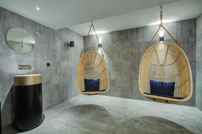 a bathroom with two hanging chairs and a mirror at The Drus Luxury Apartment with Spa and Indoor Pool in Chamonix-Mont-Blanc